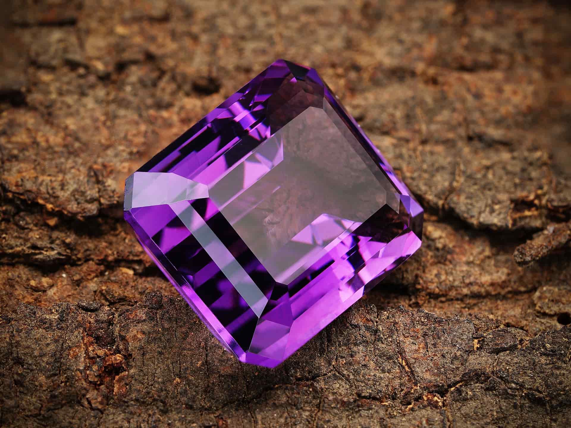 Macro photograph of faceted clear gemstones catching light