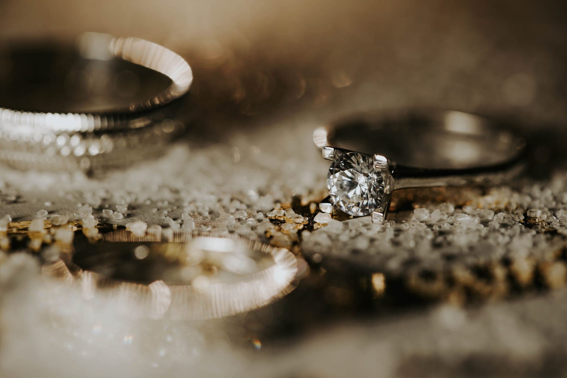 A diamond stud earring photographed against a soft background